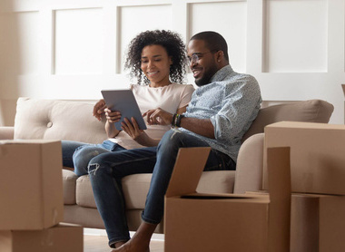 iStock homeowner sofa tablet laptop.jpg